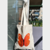 . Tote bag 100% natural cotton. length 38cm x 42cm handle length:27 inch. Colour sand colour. bag hanging on the door